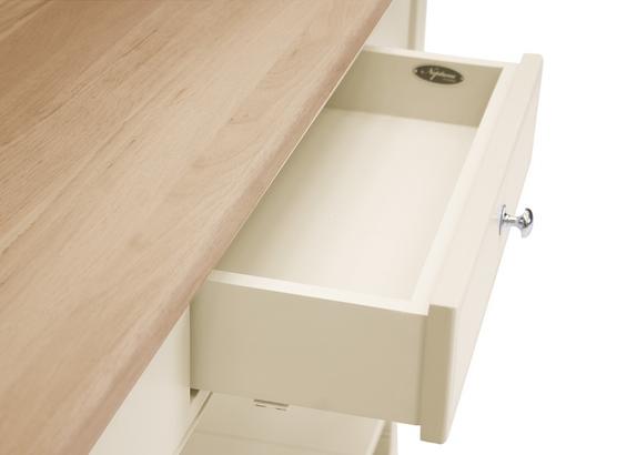 Detailansicht einer geöffneten weißen Schublade unter einer hellen Holzplatte
