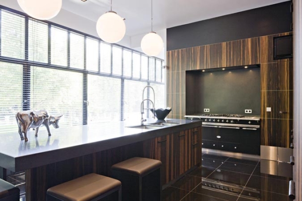 Helle moderne Küche mit großer Kochinsel, Holzdekor, Hockern, großen Fenstern und Design-Accessoires